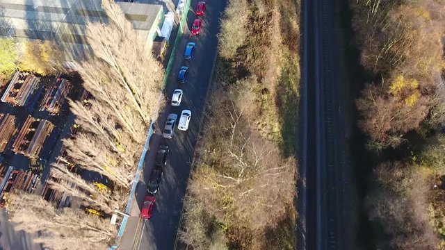 Aerial view following a white van driving on a road.