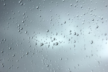 Falling raindrops on glass  