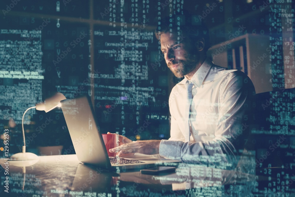 Poster Businessman using laptop at night