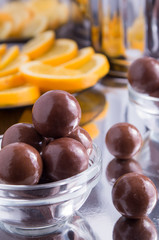 Chocolate candies in a small glass bowl close-up with blur