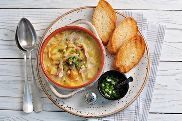 Cheese soup with mushrooms, chicken, potatoes and carrots.