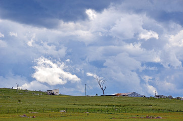 Ominous storm clouds approaching over rolling green hills and farmland in the New South Wales countryside, Australia