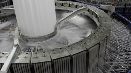 Textile industry - yarn spools on spinning machine in a factory