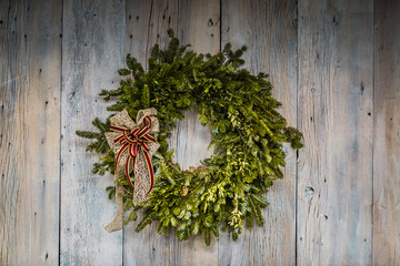 Evergreen Christmas wreath on barn siding