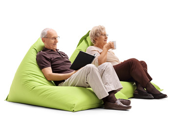 Elderly man and woman sitting on beanbags