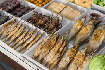 Salted grilled fish on the grill in market