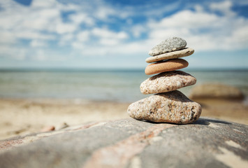 Fototapeta na wymiar Stack of stones on the seaside in summer