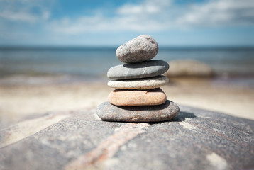 Fototapeta na wymiar Stack of stones on the seaside in summer