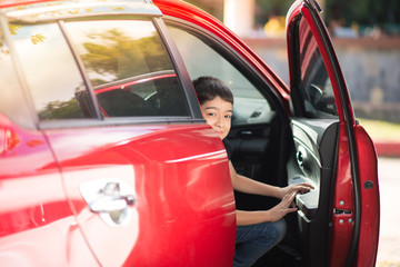 Little boy opening car's door