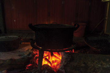 a fire in the woods on which is brewed pot,cooking in the kitchen ,vietnam local house