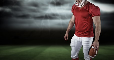 Composite image of american football player with ball