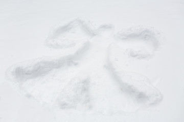angel silhouette or print on snow surface