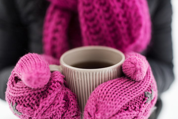 close up of woman with tea mug outdoors in winter