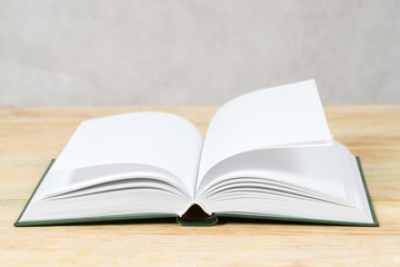 Open book on wooden table. Back to school. Copy space