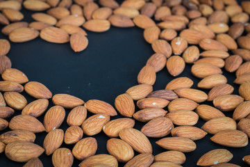 close up almonds nuts on black background