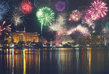 Night panoramic view of Eilat with festive fireworks. Red Sea coast. Israel. Seaside with water...