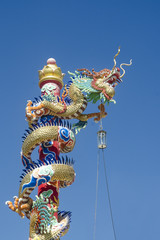 The Chinese dragon statue with blue sky background.