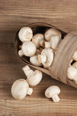 Basket with mushrooms on wooden background