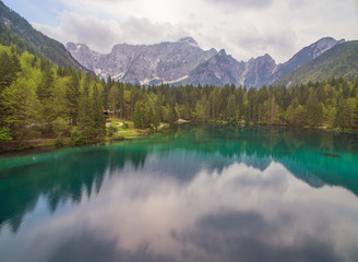 Naklejka na ściany i meble Aerial: Beautiful Mountain Lake Landscape With Panoramic View Of Mountain Alps On Background