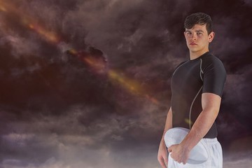 Obraz premium Composite image of rugby player holding a rugby ball