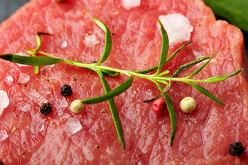 Fresh Raw Beef steak Mignon with sea salt and rosemary, balck pepper .closeup