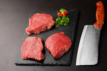 Fresh and raw meat.. Background black blackboard