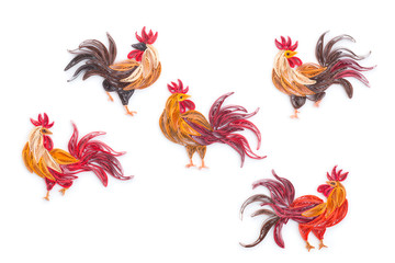 quilling handmade picture roosters out of colored paper on white