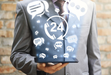 man hold tablet with 24/7 handset circle arrow technical support service icon cloud bubbles talk...