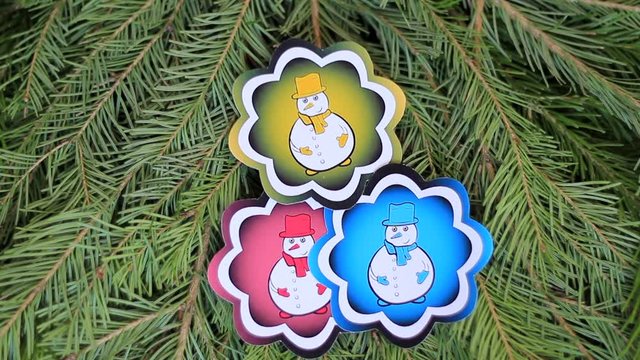Color snowmen fir-tree branch