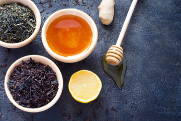 Wooden bowl with a dry tea and fresh honey, lemon and ginger. To
