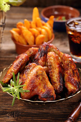 Chicken wings with baked potatoes and barbecue sauce