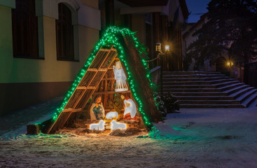 Nativity scene near a church at night in Kiev