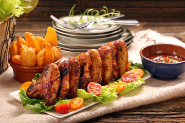 Chicken wings with baked potatoes and barbecue sauce