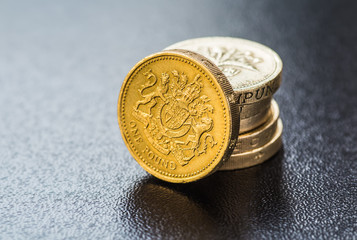 British coins stack on black, pound sterling