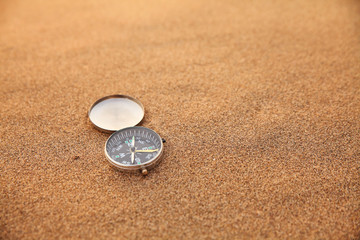 Fototapeta na wymiar Compass on the sand.