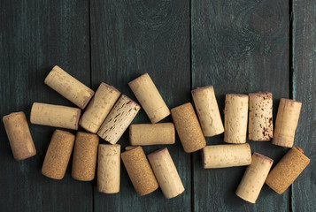 Wine corks on dark wooden texture with copyspace