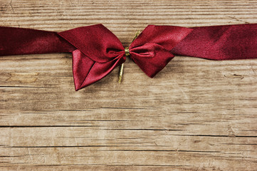 red bow and ribbon on the old wooden background