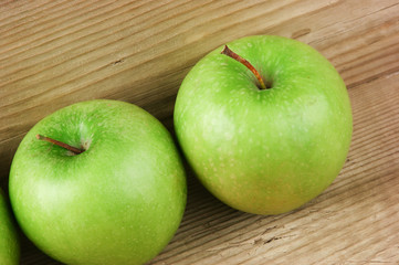 green apples on a wooden background