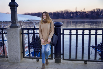 Walk along the promenade in the autumn, beautiful woman