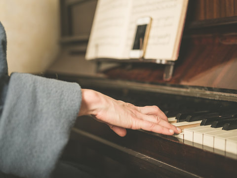 Hands of woman playing piano
