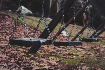 Old wooden swing in a park