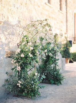 Floral arch against wall