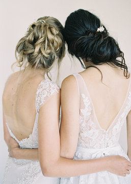 Two women wearing bridal wear, rear view