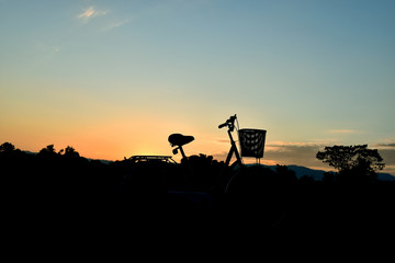 Silhouette of bicycle on a background of the sunset