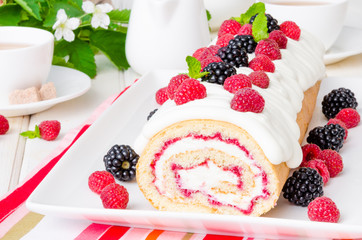 Vanilla roulade with raspberry jam and butter cream on a white background