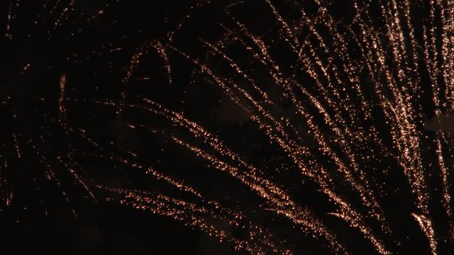Close up on firework explosions at night.