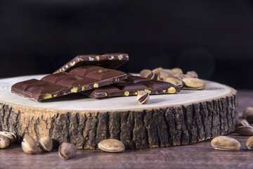 Chocolate and Pistachio nuts on the wood table, wood background
