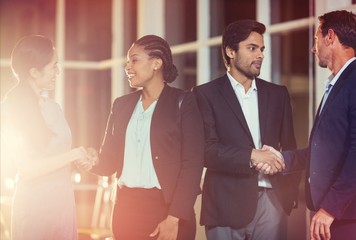 Group of business people shaking hands with each other