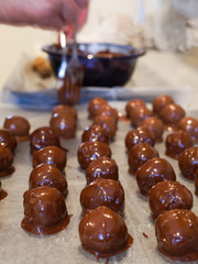 A Christmas favorite, homemade peanut butter chocolate balls. A mixture of peanut butter, nuts, sugar and other sweet stuff and then dipped in milk chocolate.