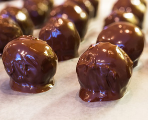 A Christmas favorite, homemade peanut butter chocolate balls. A mixture of peanut butter, nuts, sugar and other sweet stuff and then dipped in milk chocolate.